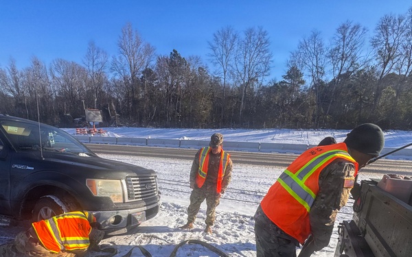 678th Air Defense Artillery Brigade vehicle-recovery team assist a stranded vehicle during Winter Storm Gianna&amp;#xA;