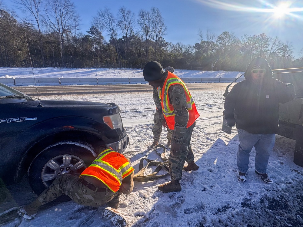 678th Air Defense Artillery Brigade vehicle-recovery team assist a stranded vehicle during Winter Storm Gianna&amp;#xA;