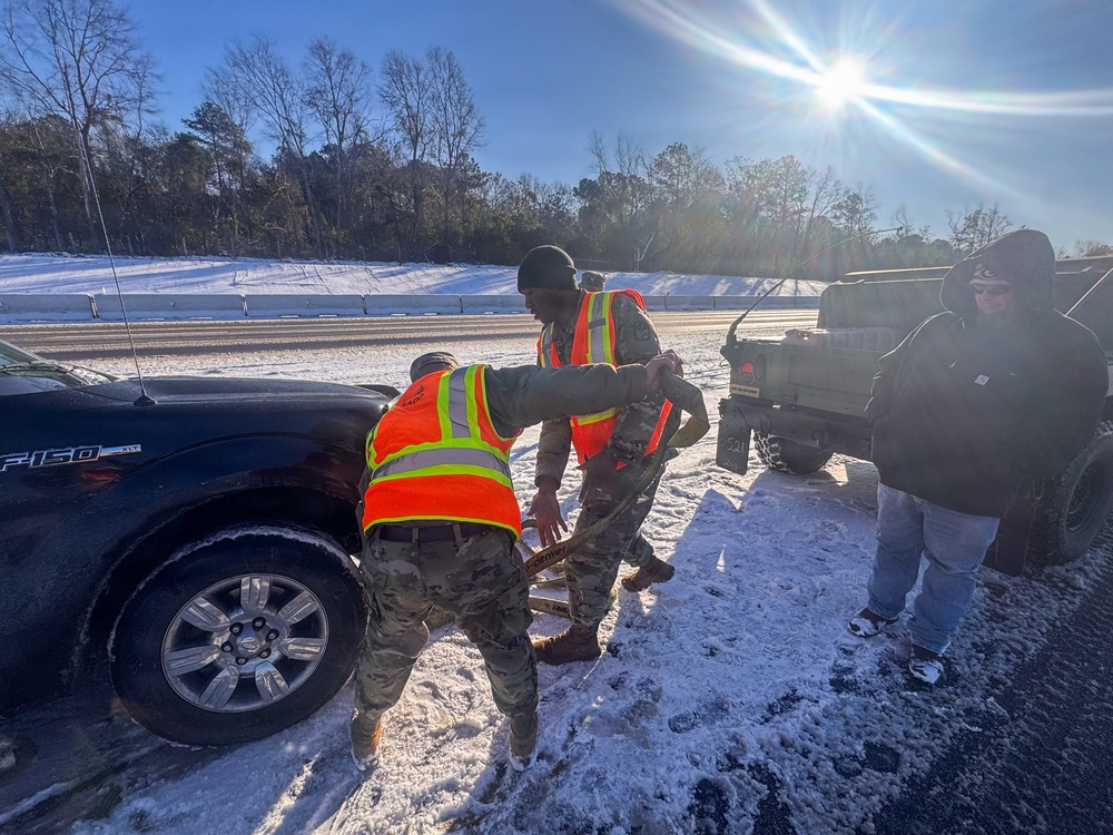 678th Air Defense Artillery Brigade vehicle-recovery team assist a stranded vehicle during Winter Storm Gianna&amp;#xA;