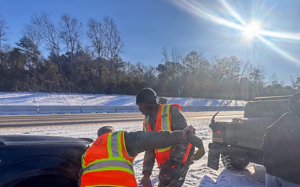 678th Air Defense Artillery Brigade vehicle-recovery team assist a stranded vehicle during Winter Storm Gianna&amp;#xA;