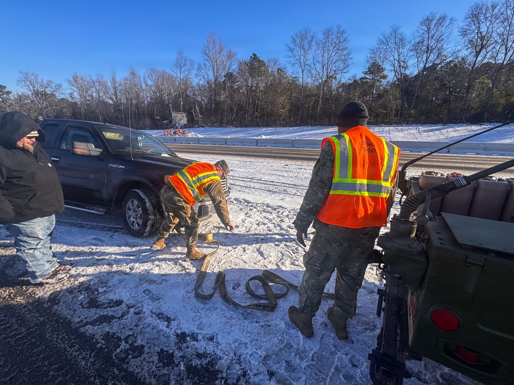 678th Air Defense Artillery Brigade vehicle-recovery team assist a stranded vehicle during Winter Storm Gianna&amp;#xA;