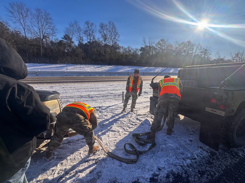 678th Air Defense Artillery Brigade vehicle-recovery team assist a stranded vehicle during Winter Storm Gianna&amp;#xA;