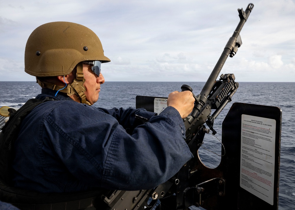 U.S. Sailor Replaces Hot Barrel of an M240B Machine Gun