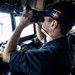 U.S. Sailor Uses Binoculars in the Pilot House