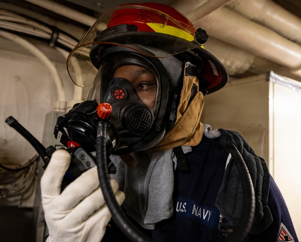 U.S. Sailor Conducts a Radio Check During a General Quarters Drill