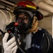 U.S. Sailor Conducts a Radio Check During a General Quarters Drill