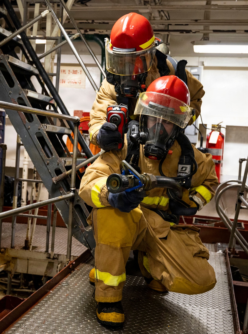 U.S. Sailors Combat a Simulated Fire During a General Quarters Drill