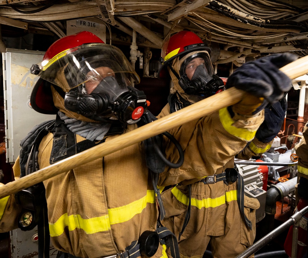 U.S. Sailors Smother a Simulated Hot Spot During a General Quarters Drill
