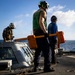 U.S. Sailors Prepare to Chock and Chain an MH-60R Sea Hawk Helicopter on the Flight Deck