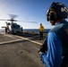 U.S. Sailors stand by to remove chocks and chains from an MH-60R Sea Hawk helicopter