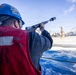 U.S. Sailor Fires a Shot Line Across the Midships
