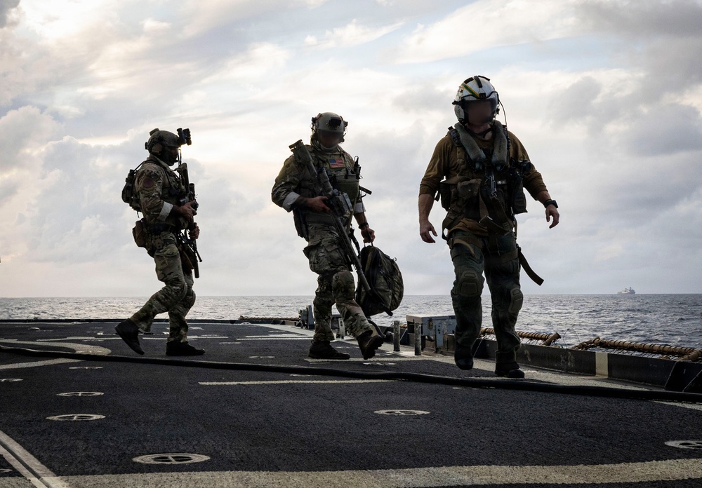 Coast Guard Tactical Team Members Exit an MH-60R Sea Hawk Helicopter During a Maritime Interception Rehearsal