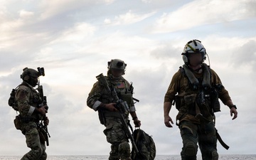 Coast Guard Tactical Team Members Exit an MH-60R Sea Hawk Helicopter During a Maritime Interception Rehearsal