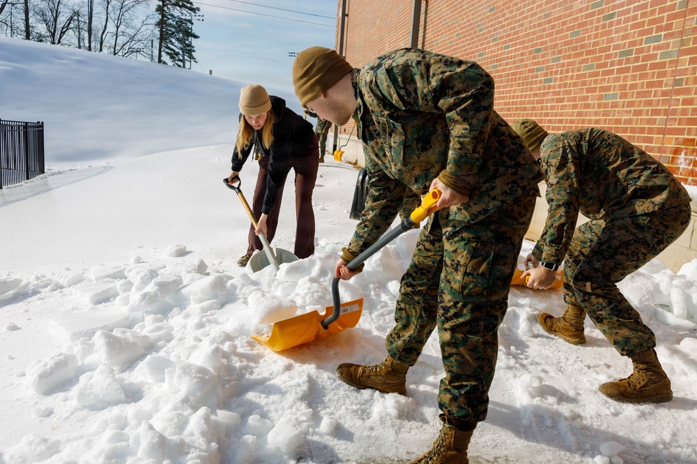 U.S. Marines with Marine Corps Base Quantico Shovel Snow for the Crossroads Elementary School