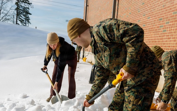 U.S. Marines with Marine Corps Base Quantico Shovel Snow for the Crossroads Elementary School