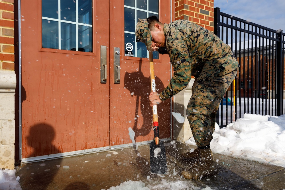 U.S. Marines with Marine Corps Base Quantico Shovel Snow for the Crossroads Elementary School