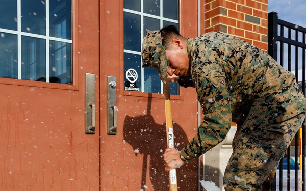 U.S. Marines with Marine Corps Base Quantico Shovel Snow for the Crossroads Elementary School