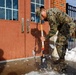 U.S. Marines with Marine Corps Base Quantico Shovel Snow for the Crossroads Elementary School