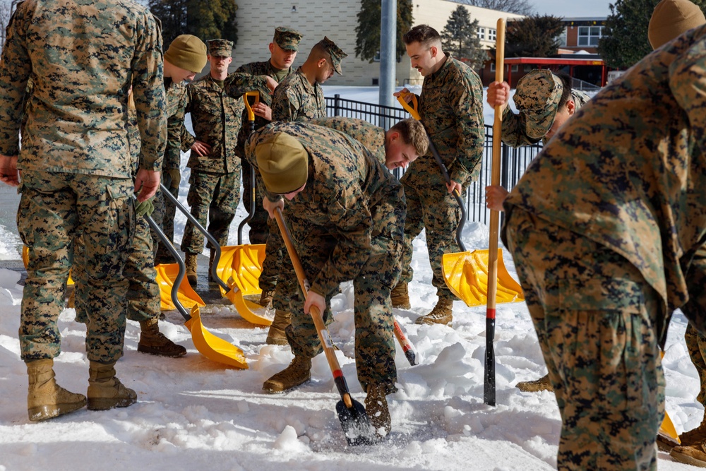 U.S. Marines with Marine Corps Base Quantico Shovel Snow for the Crossroads Elementary School