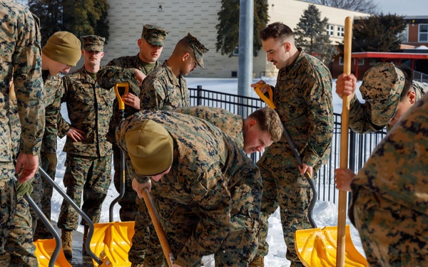 U.S. Marines with Marine Corps Base Quantico Shovel Snow for the Crossroads Elementary School