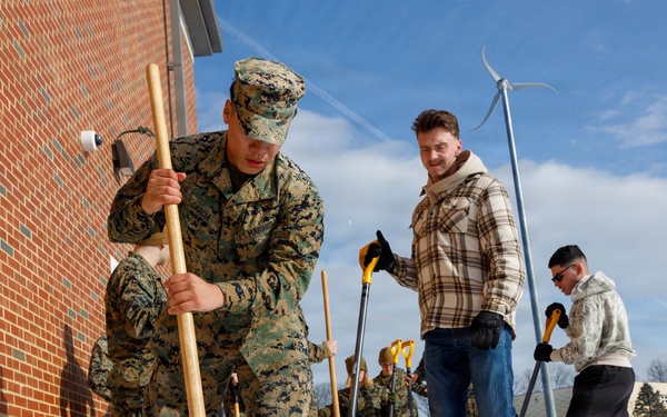 U.S. Marines with Marine Corps Base Quantico Shovel Snow for the Crossroads Elementary School