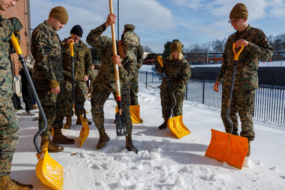 U.S. Marines with Marine Corps Base Quantico Shovel Snow for the Crossroads Elementary School