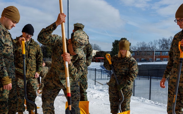 U.S. Marines with Marine Corps Base Quantico Shovel Snow for the Crossroads Elementary School