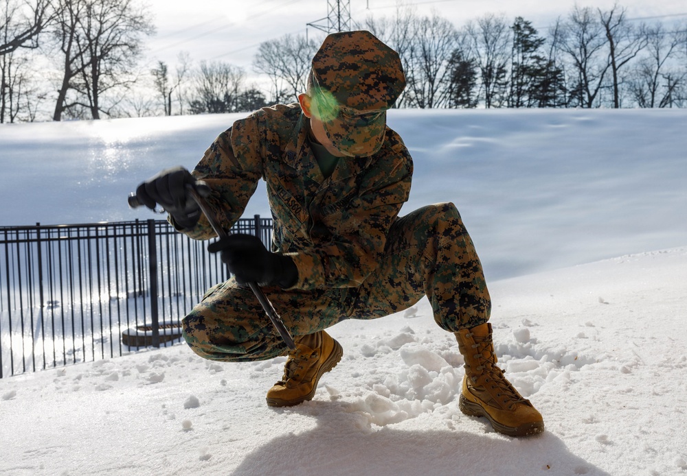 U.S. Marines with Marine Corps Base Quantico Shovel Snow for the Crossroads Elementary School
