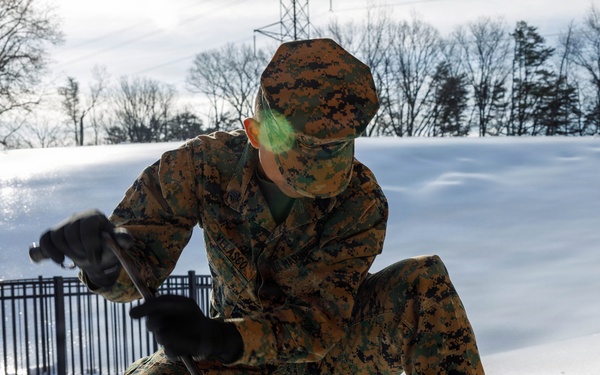 U.S. Marines with Marine Corps Base Quantico Shovel Snow for the Crossroads Elementary School
