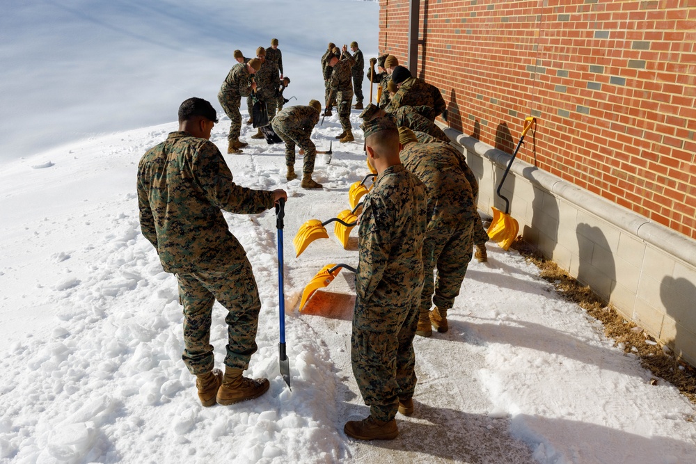 U.S. Marines with Marine Corps Base Quantico Shovel Snow for the Crossroads Elementary School
