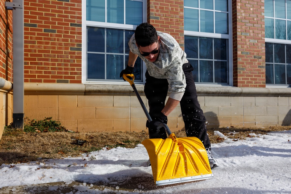 U.S. Marines with Marine Corps Base Quantico Shovel Snow for the Crossroads Elementary School