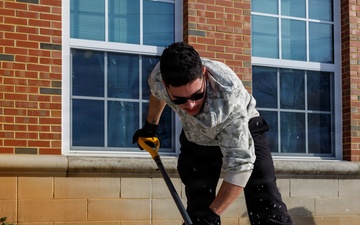 U.S. Marines with Marine Corps Base Quantico Shovel Snow for the Crossroads Elementary School