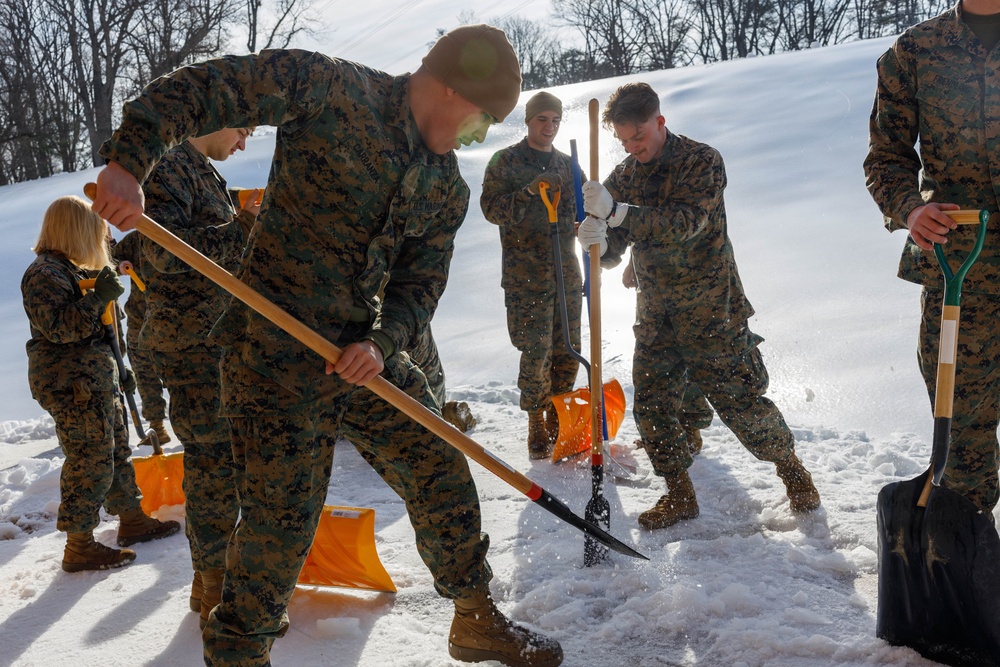U.S. Marines with Marine Corps Base Quantico Shovel Snow for the Crossroads Elementary School