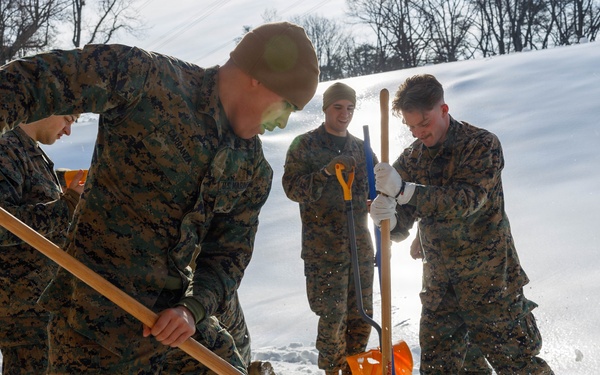 U.S. Marines with Marine Corps Base Quantico Shovel Snow for the Crossroads Elementary School