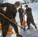 U.S. Marines with Marine Corps Base Quantico Shovel Snow for the Crossroads Elementary School