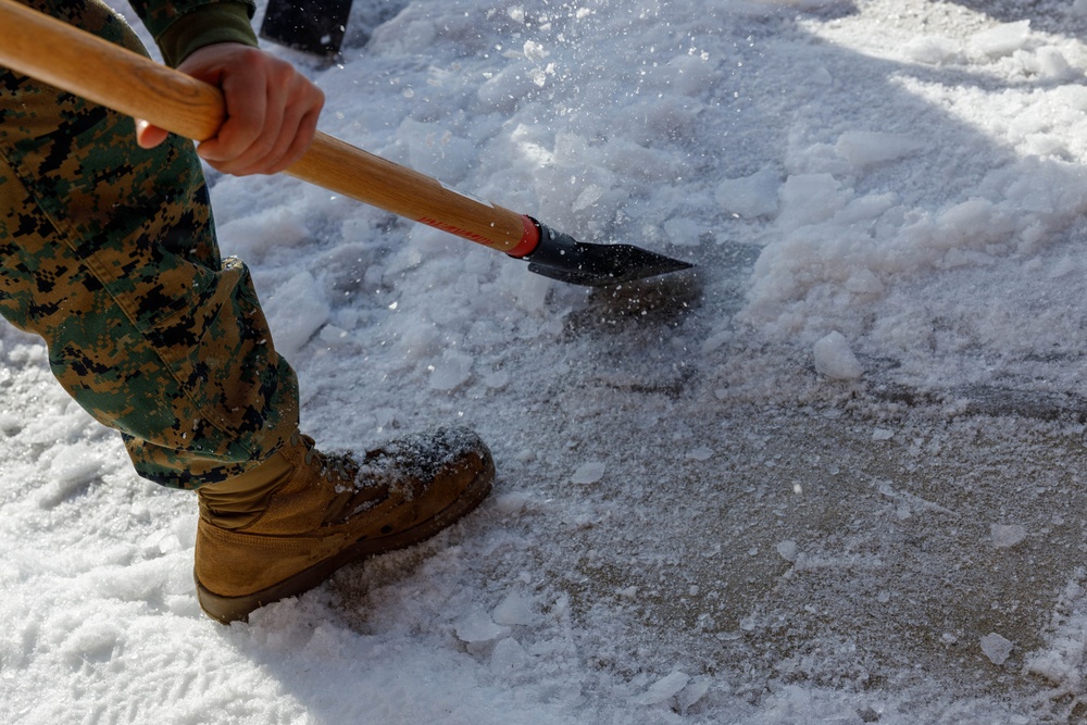 U.S. Marines with Marine Corps Base Quantico Shovel Snow for the Crossroads Elementary School