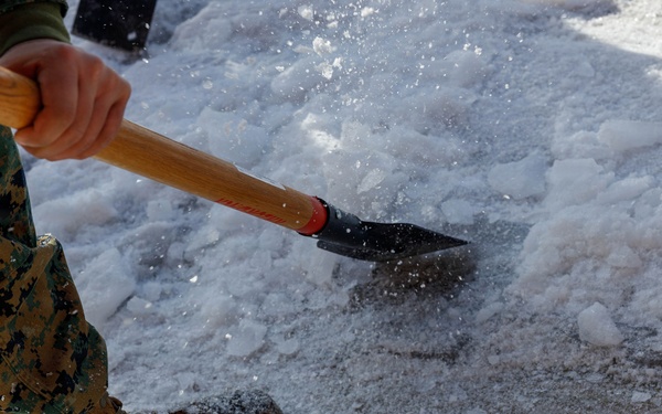 U.S. Marines with Marine Corps Base Quantico Shovel Snow for the Crossroads Elementary School