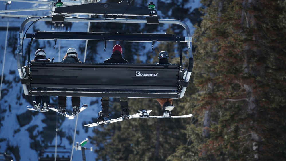 Riders Share Ski Lift at Mountain Resort