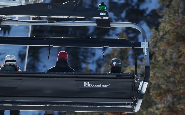 Riders Share Ski Lift at Mountain Resort