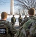 Service members clear snow at the Washington Monument