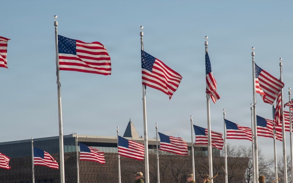 Service members clear snow at the Washington Monument