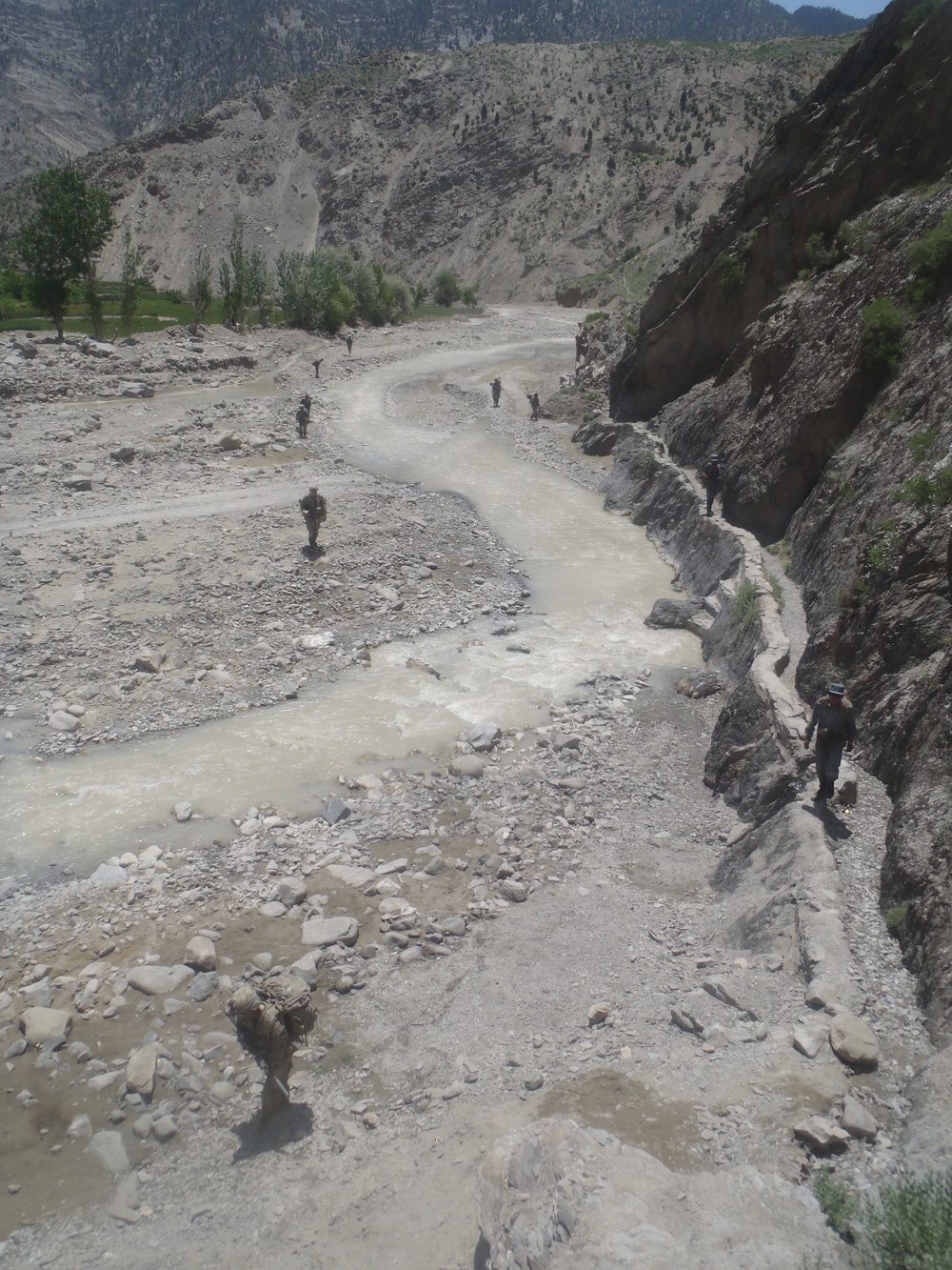 Soldiers patrolling through a Wadi