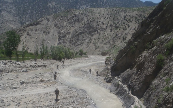 Soldiers patrolling through a Wadi