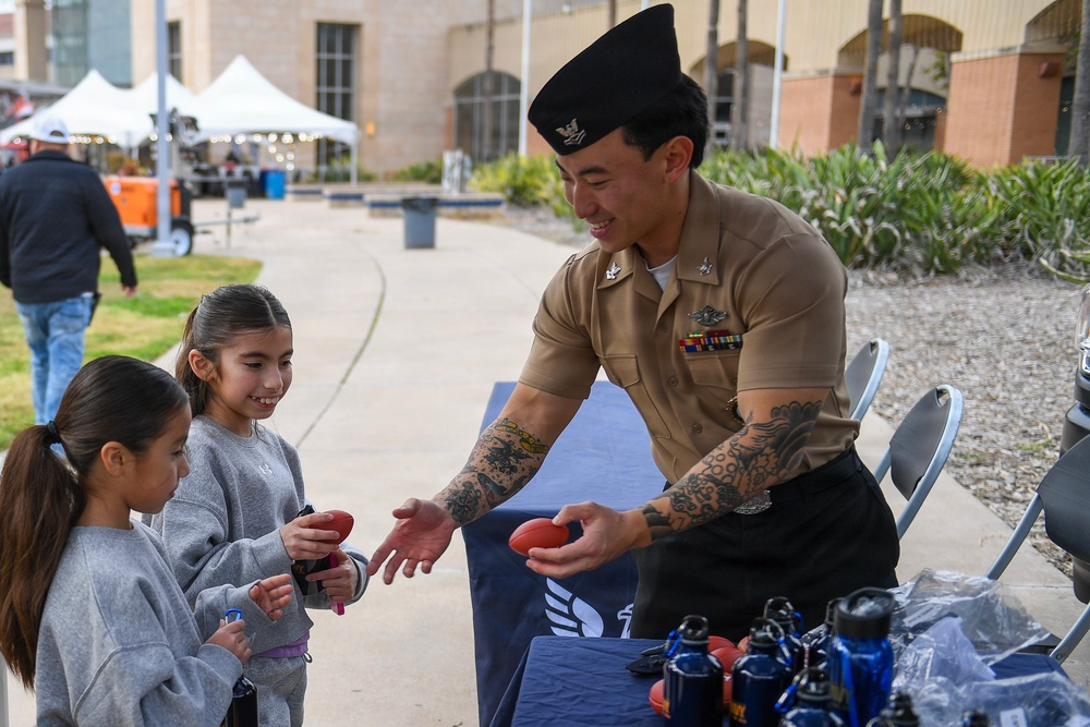 HM2 Ahn passes out free merchandise to civilians at Carfest 2026 in McAllen, TX