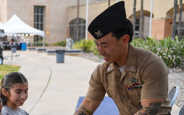 HM2 Ahn passes out free merchandise to civilians at Carfest 2026 in McAllen, TX