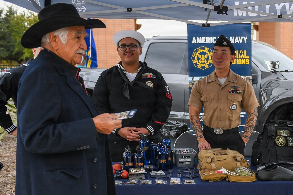 EN2 Olvera and HM2 Ahn listen to a story from a veteran that stopped at their table
