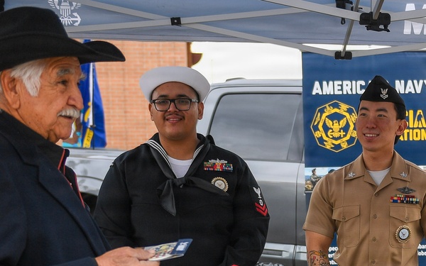 EN2 Olvera and HM2 Ahn listen to a story from a veteran that stopped at their table