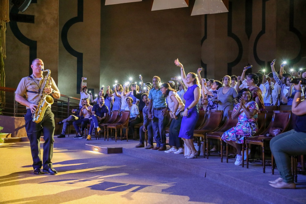 U.S. Naval Forces Europe and Africa Band (Topside Brass Band) perform for students and staff of the Mahatma Gandhi Institute Secondary School (MGISS)