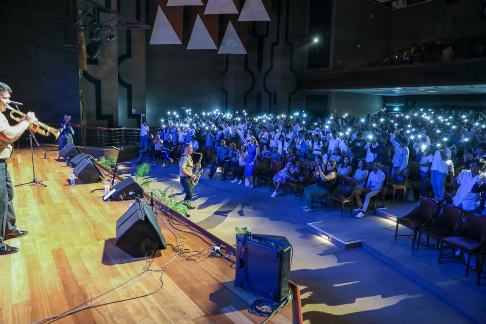 U.S. Naval Forces Europe and Africa Band (Topside Brass Band) perform for students and staff of the Mahatma Gandhi Institute Secondary School (MGISS)