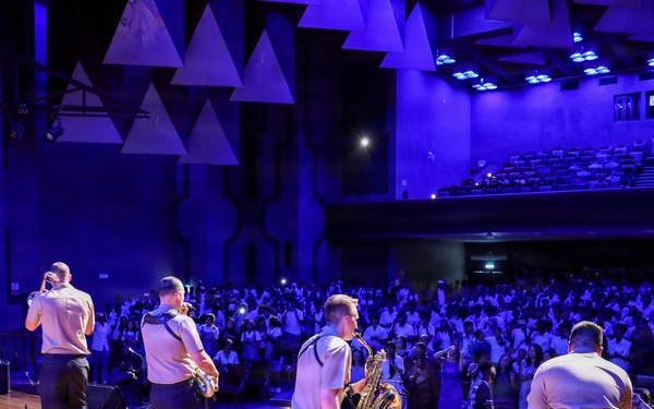 U.S. Naval Forces Europe and Africa Band (Topside Brass Band) play a concert for students and staff of the Mahatma Gandhi Institute Secondary School (MGISS)